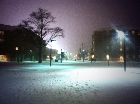 Snow falls in front of Dominion House, Old Dominion University